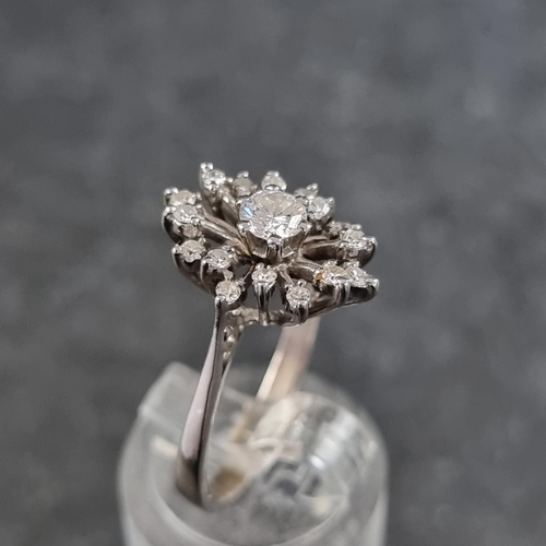 120 - A diamond starburst cluster ring, set central brilliant cut diamond of approximately 0.25ct surround... 