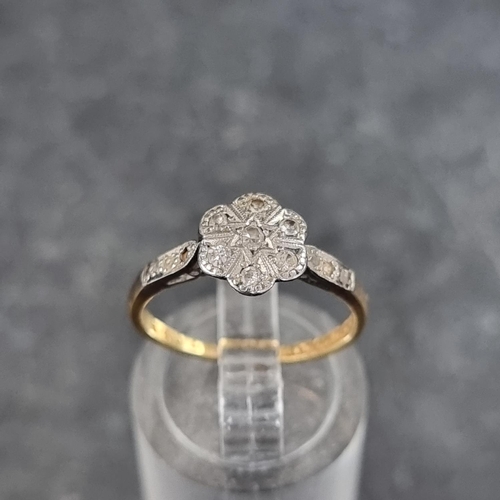 126 - A 18ct gold and platinum diamond daisy ring, size K 1/2, gross weight 2.3g.