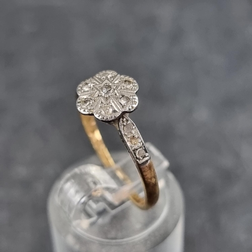 126 - A 18ct gold and platinum diamond daisy ring, size K 1/2, gross weight 2.3g.