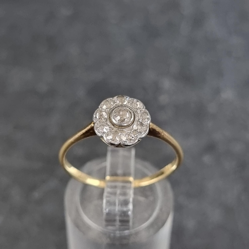 127 - A yellow metal diamond cluster daisy ring, stamped 18k, set ten diamonds, size S.