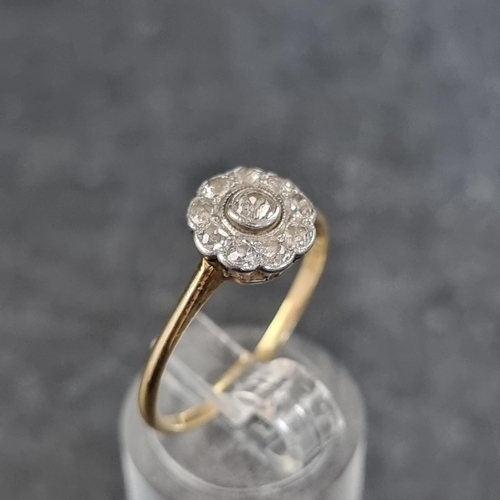 127 - A yellow metal diamond cluster daisy ring, stamped 18k, set ten diamonds, size S.