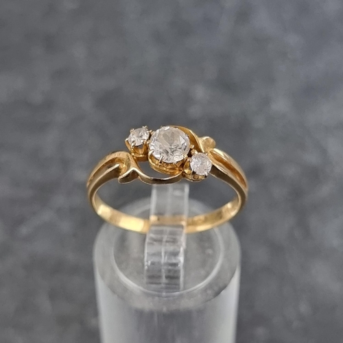 128 - A yellow metal diamond three stone ring, the principal stone approximately 0.25ct, stamped '18ct', s... 