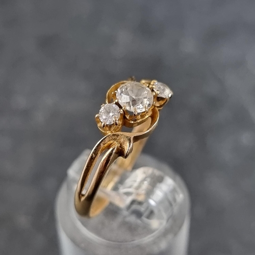 128 - A yellow metal diamond three stone ring, the principal stone approximately 0.25ct, stamped '18ct', s... 