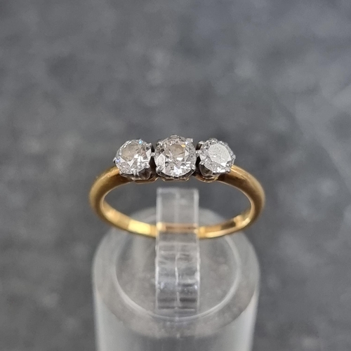 129 - A yellow metal diamond three stone ring, the central stone of approximately 0.15ct, stamped 18ct, si... 