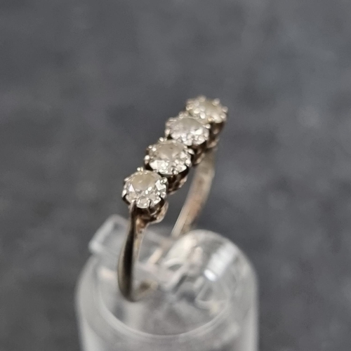 137 - An Edwardian white metal and diamond four stone ring, stamped '18ct/Plat', size L 1/2.... 