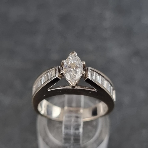 138 - A marquise diamond ring, with eighteen diamonds to shoulders, stamped '18ct', size M.... 