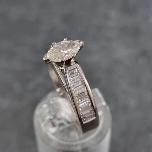 138 - A marquise diamond ring, with eighteen diamonds to shoulders, stamped '18ct', size M.... 