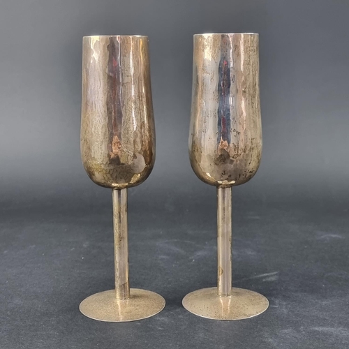 14 - A pair of hammered silver wine flutes, by Pruden & Smith, Sheffield 2001, 19cm high, 341g.... 