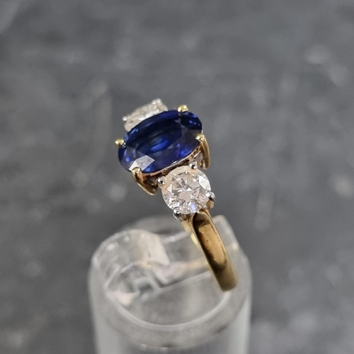 149 - A modern 18ct gold diamond and sapphire three stone ring, set central oval sapphire with a brilliant... 