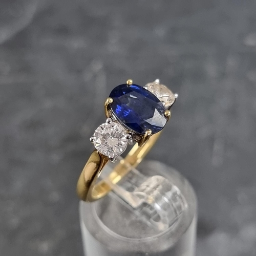 149 - A modern 18ct gold diamond and sapphire three stone ring, set central oval sapphire with a brilliant... 