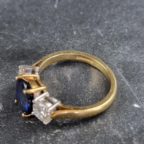 149 - A modern 18ct gold diamond and sapphire three stone ring, set central oval sapphire with a brilliant... 