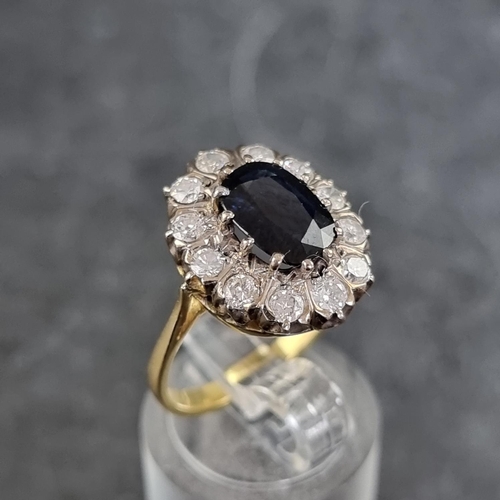 152A - An 18ct gold diamond and sapphire cluster ring, set facetted sapphire surrounded by twelve brilliant... 