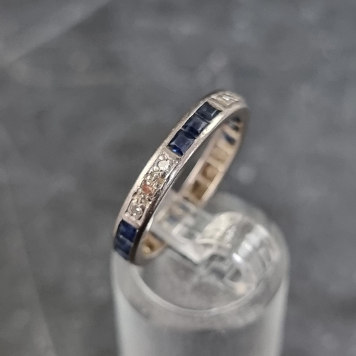 155 - A white metal eternity ring, set twelve calibre sapphires and twelve small diamonds, size N.... 