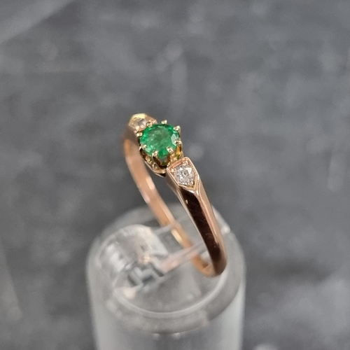 159 - A yellow metal emerald and diamond three stone ring, stamped '585', size Q.