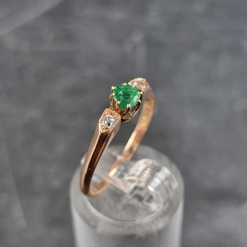 159 - A yellow metal emerald and diamond three stone ring, stamped '585', size Q.