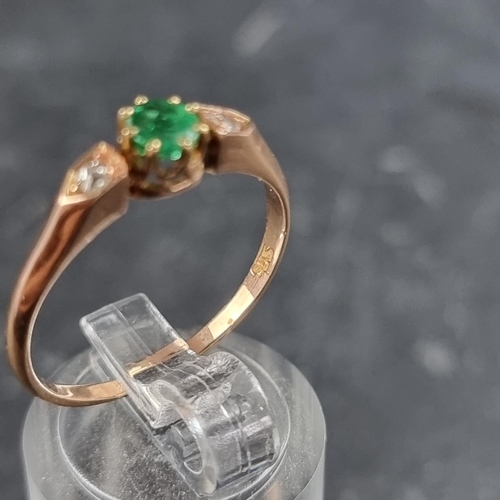 159 - A yellow metal emerald and diamond three stone ring, stamped '585', size Q.