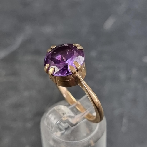 168 - A yellow metal amethyst ring, stamped '9ct', size O.