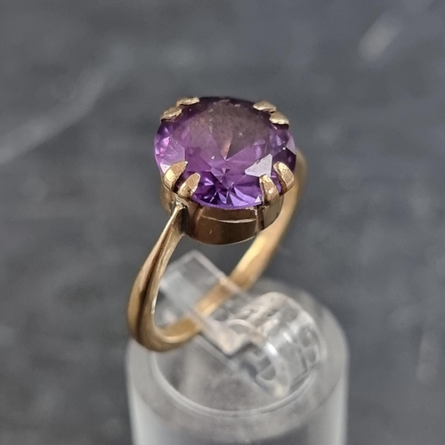 168 - A yellow metal amethyst ring, stamped '9ct', size O.