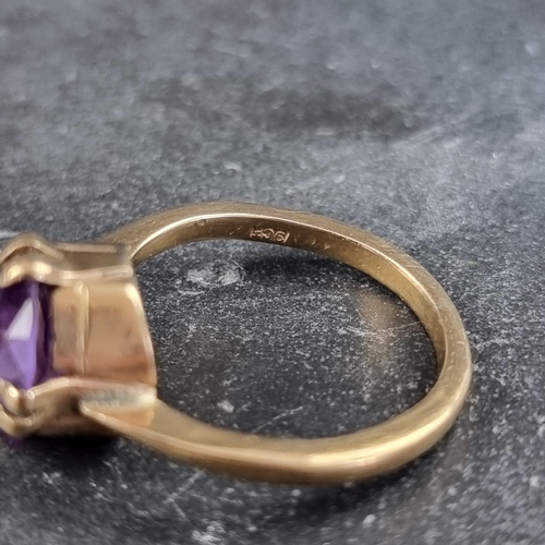 168 - A yellow metal amethyst ring, stamped '9ct', size O.