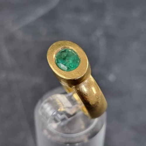 171 - A yellow metal emerald solitaire ring, in a rub over setting, size M, unmarked.