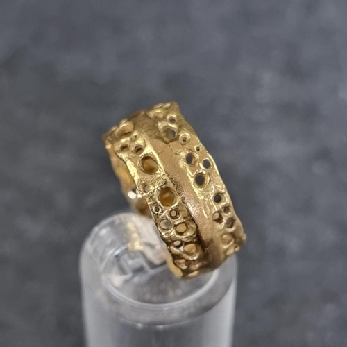 177 - A pierced 18ct gold ring, by A V, London 1997, size P, 7.9g.