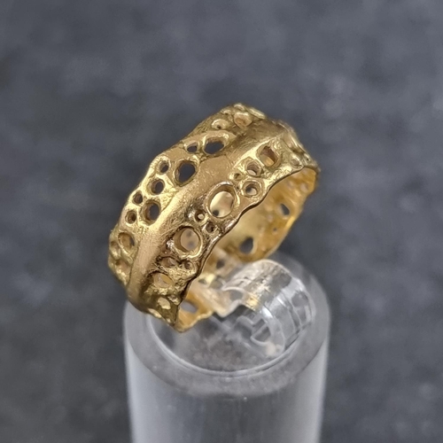 177 - A pierced 18ct gold ring, by A V, London 1997, size P, 7.9g.