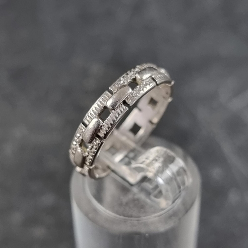 189 - A pierced chain link style ring, stamped Platinum, size K.