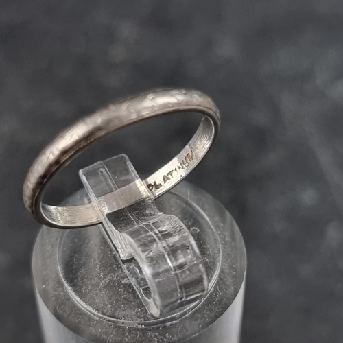 190 - A white metal wedding band, stamped 'platinum', size L.