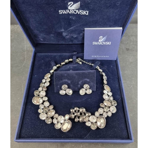 194 - A Swarovski 'Diva Moonlight' necklace and matching ear studs, cased with certificate.... 