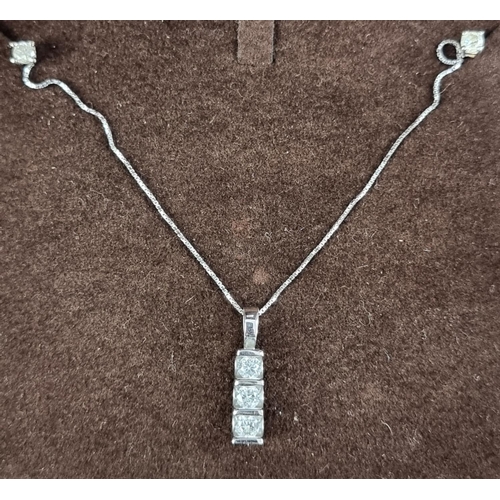 197 - A 9ct white gold pendant, set three brilliant cut diamonds, on a fine box link chain, having clasp s... 