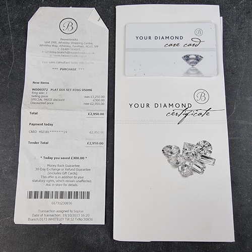 207 - A platinum diamond wedding band, by Beaverbrooks, channel set with multiple small brilliant cut diam... 