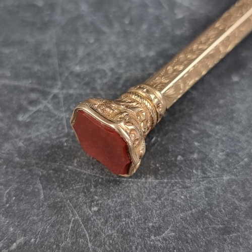 211 - A Victorian yellow metal propelling pencil, the terminal inset carnelian, approximately 10cm closed.... 