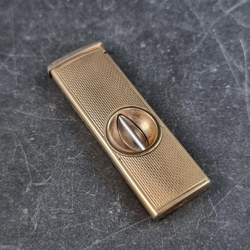 213 - An engine turned 9ct gold cigar cutter, by W M Ltd, Birmingham 1965, 5.3cm closed, gross weight 12.2... 