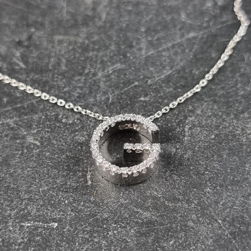 219 - An 18ct white gold pendant, set small diamonds, 11mm on a fine 18ct gold chain, 45.5cm, gross weight... 