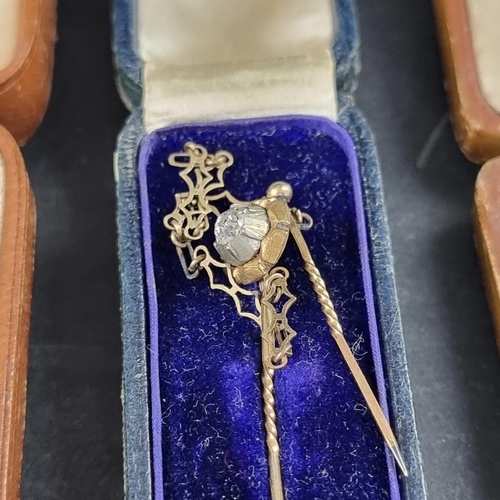 220 - A yellow metal stick pin, set old cut diamond, 6cm; together with another diamond set stick pin; and... 