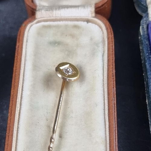 220 - A yellow metal stick pin, set old cut diamond, 6cm; together with another diamond set stick pin; and... 