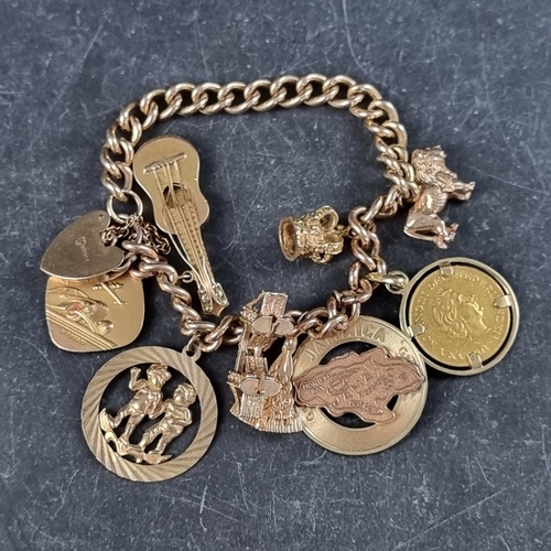 221 - A 9ct gold curb link bracelet, with padlock clasp, with four attached 9ct gold charms, three yellow ... 