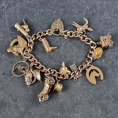 222 - A 9ct gold curb link bracelet, having padlock clasp, with thirteen attached gold charms, 50.7g.... 