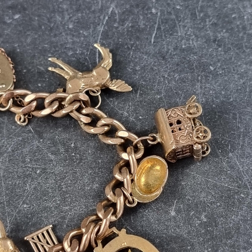 222 - A 9ct gold curb link bracelet, having padlock clasp, with thirteen attached gold charms, 50.7g.... 