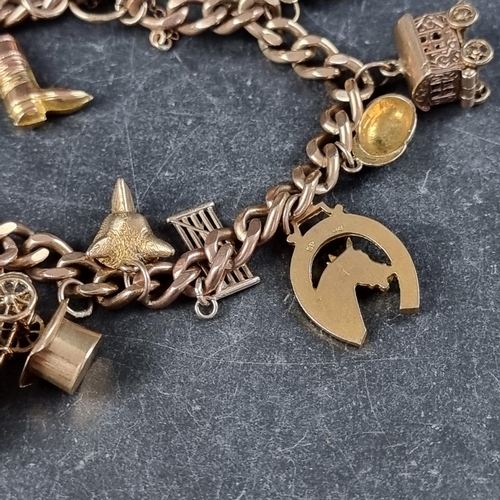 222 - A 9ct gold curb link bracelet, having padlock clasp, with thirteen attached gold charms, 50.7g.... 