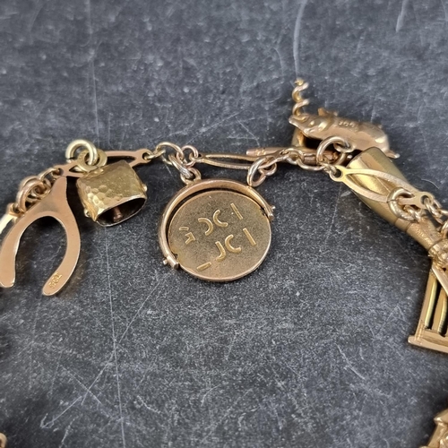 233 - A yellow metal bracelet, stamped 9c, with fourteen attached charms stamped 9c or 375.... 