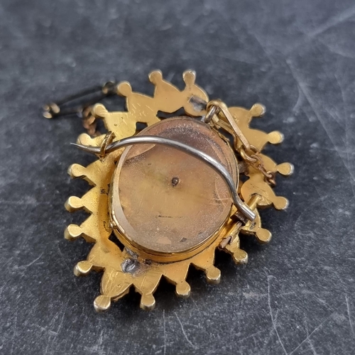 234 - A 19th century Bohemian gilt metal and garnet brooch/pendant, with locket back, 40mm high.... 