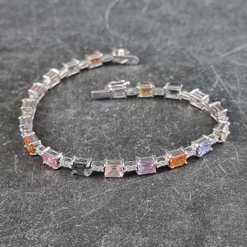 240 - A white metal multicoloured sapphire and diamond set bracelet, stamped 750, having twenty octagonal ... 