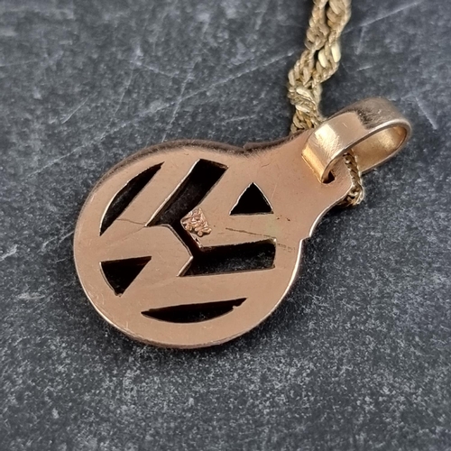 253 - A yellow metal VW pendant, 24mm high including bale, on a chain stamped 10k, 61cm long; together wit... 