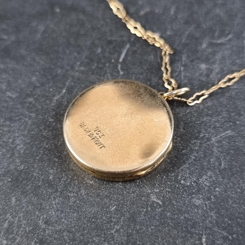 259 - A yellow metal front and back locket, stamped 9ct, on a yellow metal chain stamped 9ct to clasp.... 