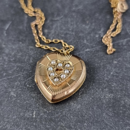 263 - A 9ct gold heart locket, set eight split pearls, 2cm high, gross weight 3.7g, on a yellow metal chai... 