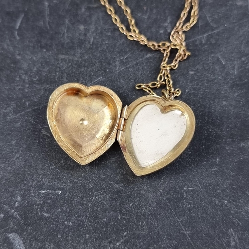 263 - A 9ct gold heart locket, set eight split pearls, 2cm high, gross weight 3.7g, on a yellow metal chai... 