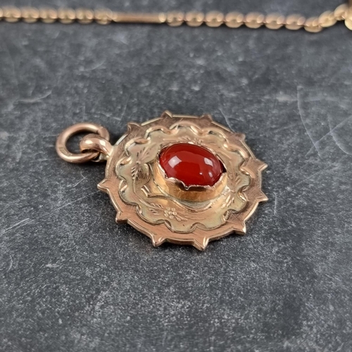 264 - A 9ct gold pendant, set central cabochon carnelian, 24mm diameter, gross weight 4.9g, on a rolled go... 