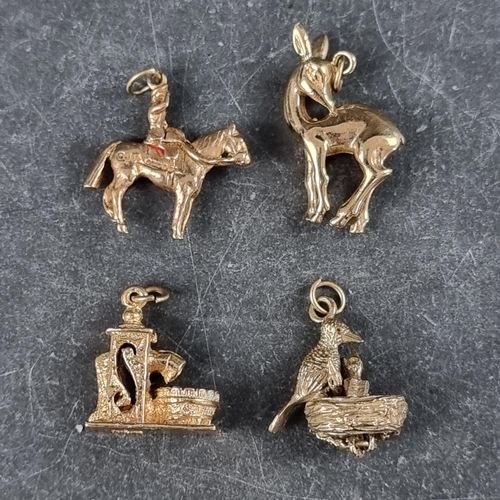 277 - Four 9ct gold charms, to include a fawn; and Queen Elizabeth II on horseback, 16.4g.... 