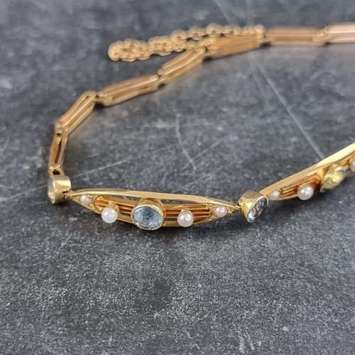 279 - An Edwardian yellow metal aquamarine and seed pearl bracelet, stamped '15c', 16cm long.... 